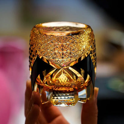 Hand holding Imperial Dark Knight Edo Kiriko whisky glass